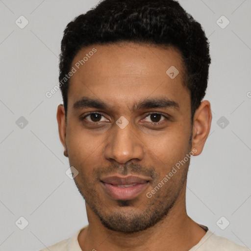 Joyful black young-adult male with short  black hair and brown eyes