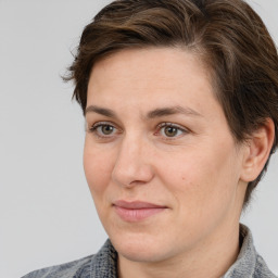 Joyful white adult female with medium  brown hair and brown eyes