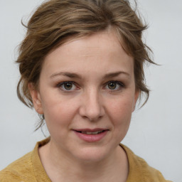 Joyful white young-adult female with medium  brown hair and blue eyes