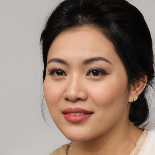 Joyful asian young-adult female with medium  brown hair and brown eyes