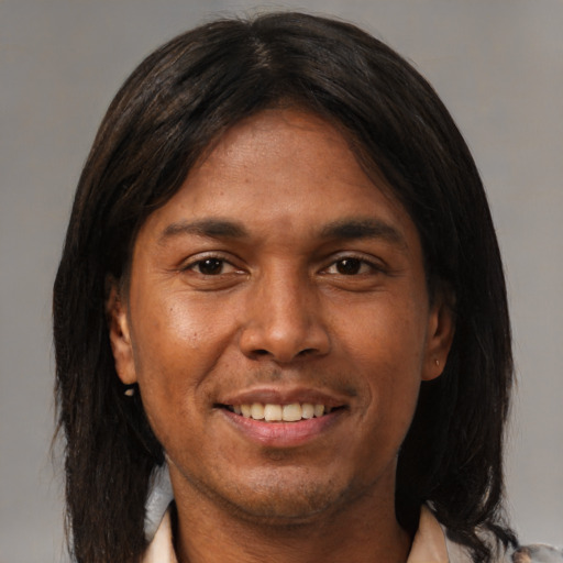 Joyful asian adult male with medium  brown hair and brown eyes
