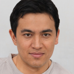 Joyful asian young-adult male with short  brown hair and brown eyes