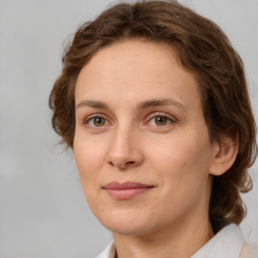 Joyful white young-adult female with medium  brown hair and green eyes