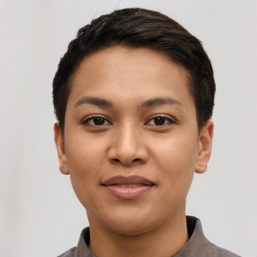 Joyful latino young-adult female with short  brown hair and brown eyes