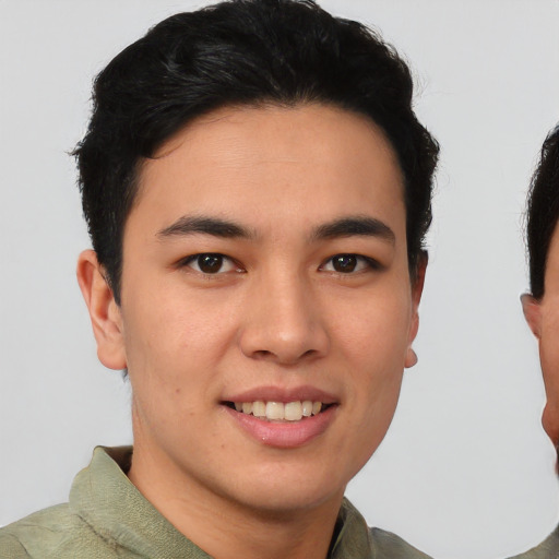 Joyful asian young-adult male with short  brown hair and brown eyes
