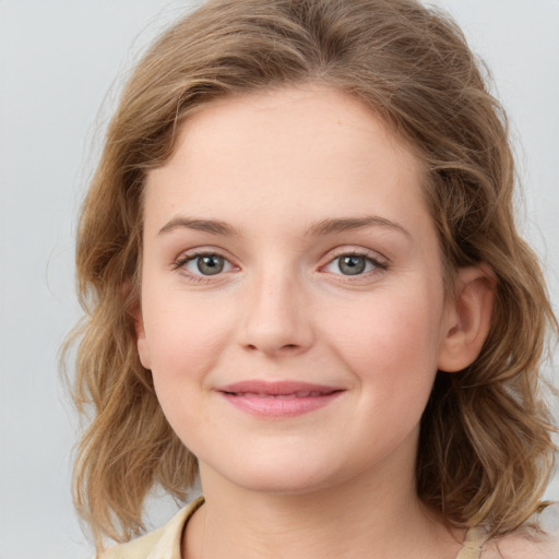 Joyful white young-adult female with medium  brown hair and blue eyes