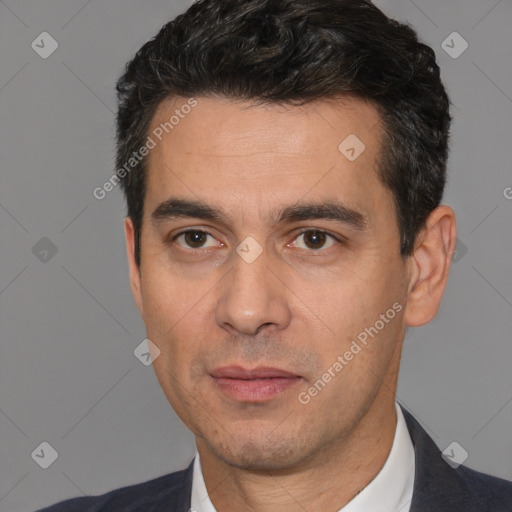 Joyful white young-adult male with short  black hair and brown eyes