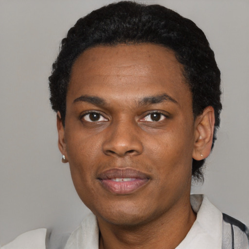 Joyful black young-adult male with short  black hair and brown eyes