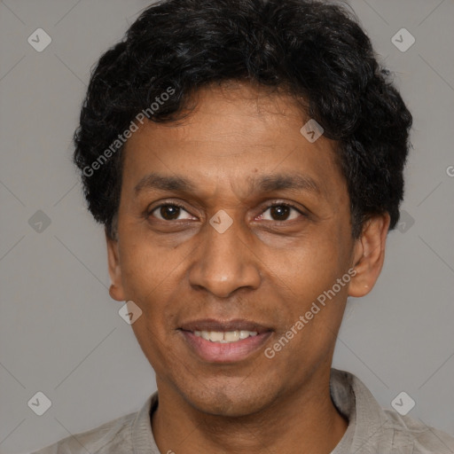 Joyful latino adult male with short  brown hair and brown eyes