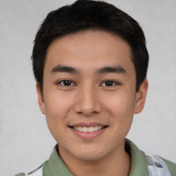 Joyful asian young-adult male with short  black hair and brown eyes