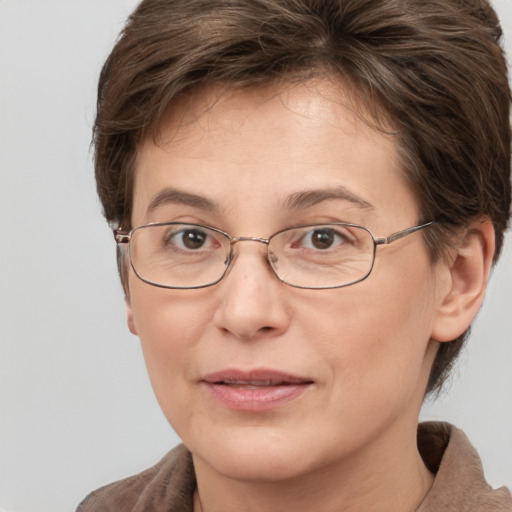 Joyful white adult female with short  brown hair and grey eyes