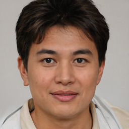 Joyful asian young-adult male with short  brown hair and brown eyes