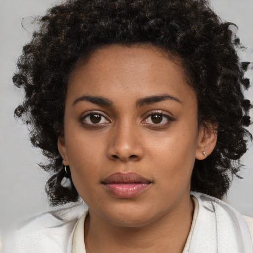 Neutral black young-adult female with medium  brown hair and brown eyes