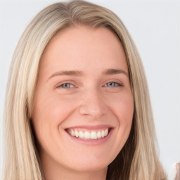 Joyful white young-adult female with long  brown hair and blue eyes