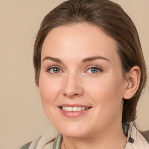 Joyful white young-adult female with medium  brown hair and grey eyes