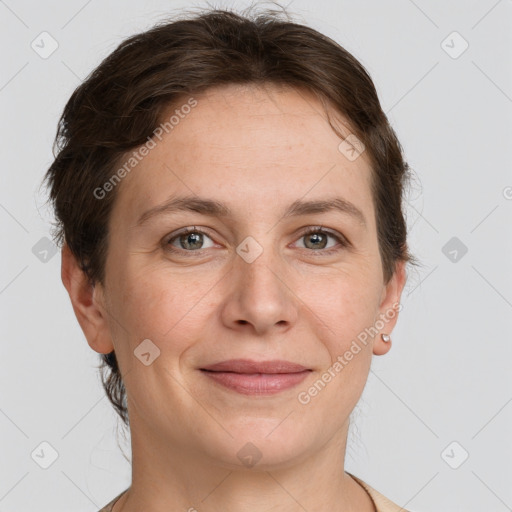 Joyful white adult female with short  brown hair and grey eyes