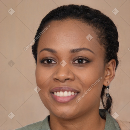 Joyful black young-adult female with long  black hair and brown eyes