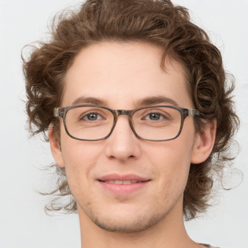 Joyful white adult male with medium  brown hair and green eyes