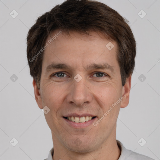 Joyful white adult male with short  brown hair and brown eyes