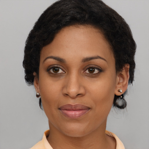 Joyful black young-adult female with medium  brown hair and brown eyes