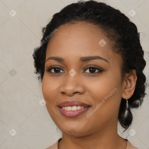 Joyful black young-adult female with long  brown hair and brown eyes