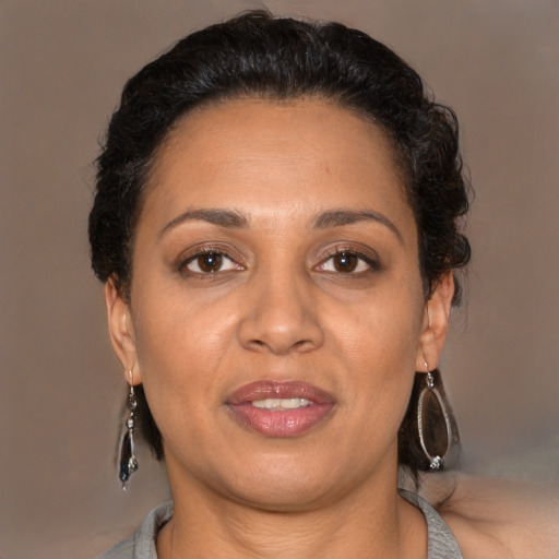 Joyful latino adult female with short  brown hair and brown eyes