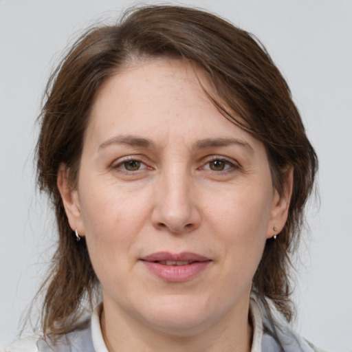 Joyful white adult female with medium  brown hair and brown eyes