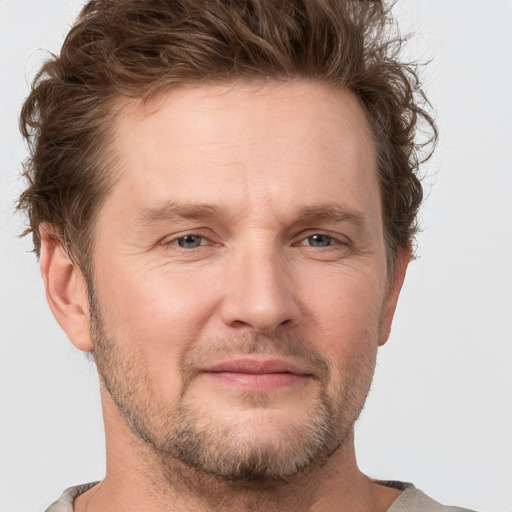 Joyful white adult male with short  brown hair and grey eyes