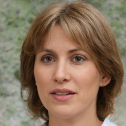 Joyful white young-adult female with medium  brown hair and green eyes