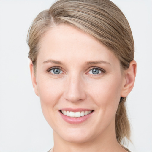 Joyful white young-adult female with medium  brown hair and blue eyes