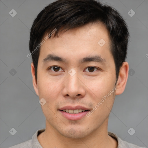 Joyful asian young-adult male with short  brown hair and brown eyes