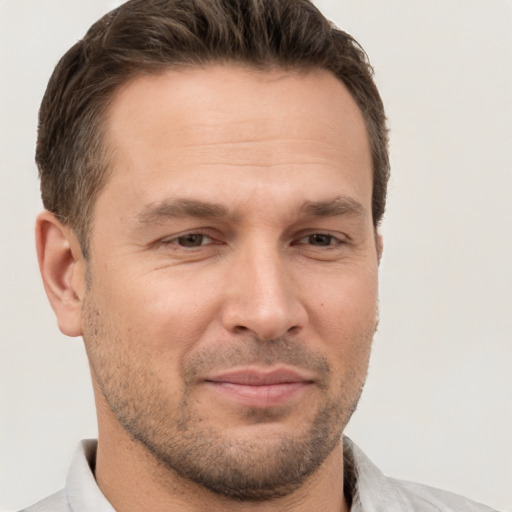 Joyful white adult male with short  brown hair and brown eyes