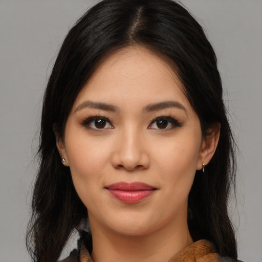 Joyful latino young-adult female with medium  brown hair and brown eyes