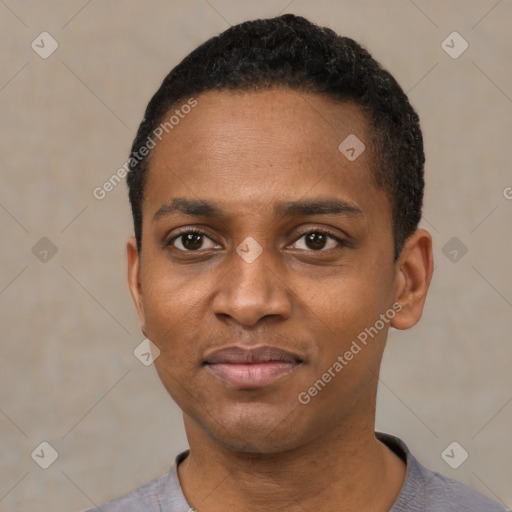 Joyful black young-adult male with short  black hair and brown eyes