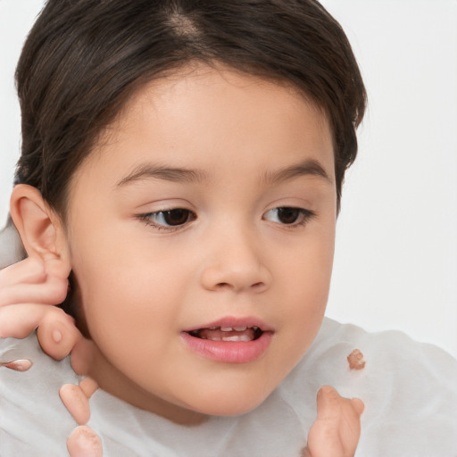 Joyful white child female with short  brown hair and brown eyes