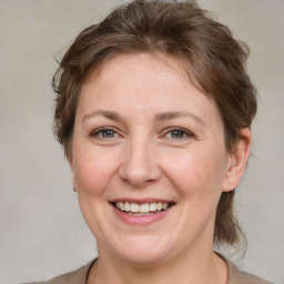 Joyful white adult female with medium  brown hair and brown eyes