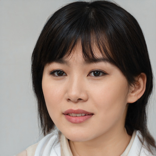 Joyful asian young-adult female with medium  brown hair and brown eyes