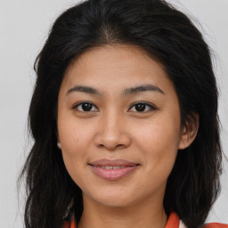 Joyful asian young-adult female with long  brown hair and brown eyes