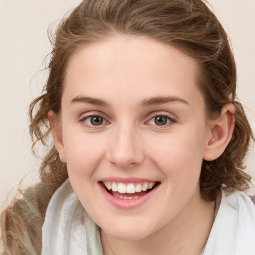 Joyful white young-adult female with medium  brown hair and blue eyes