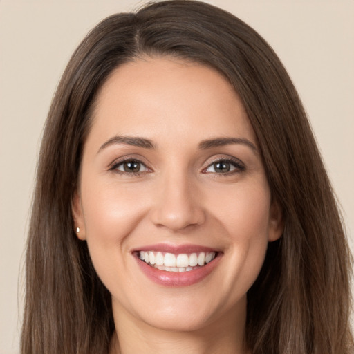 Joyful white young-adult female with long  brown hair and brown eyes