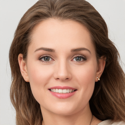 Joyful white young-adult female with long  brown hair and grey eyes