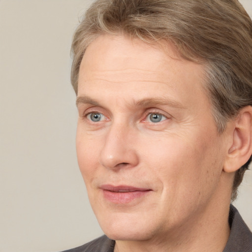 Joyful white adult male with short  brown hair and grey eyes