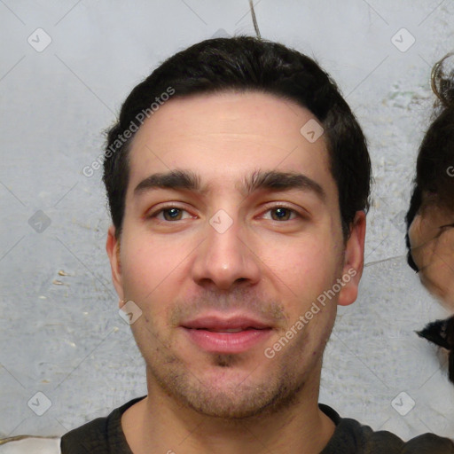 Joyful white young-adult male with short  black hair and brown eyes