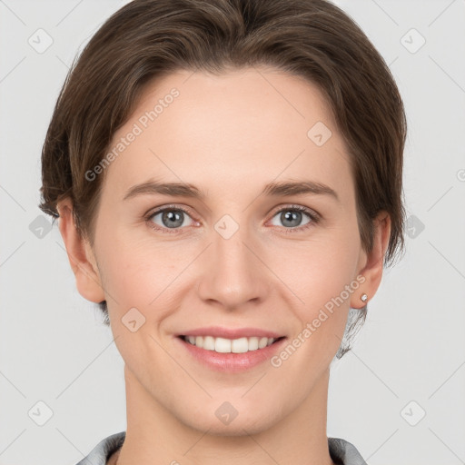 Joyful white young-adult female with short  brown hair and grey eyes