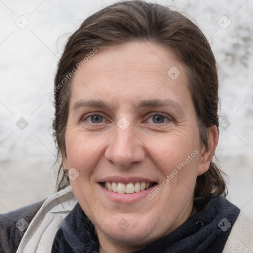 Joyful white adult female with medium  brown hair and grey eyes