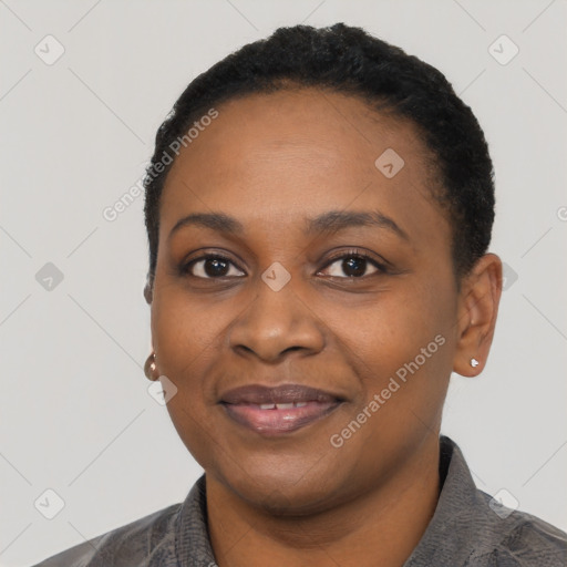 Joyful black young-adult female with short  black hair and brown eyes