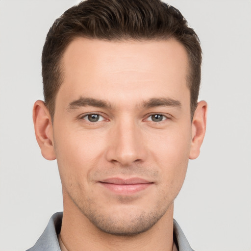 Joyful white young-adult male with short  brown hair and brown eyes