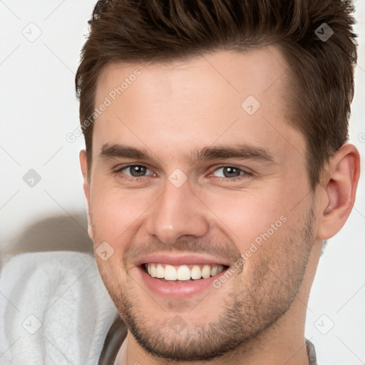 Joyful white young-adult male with short  brown hair and brown eyes