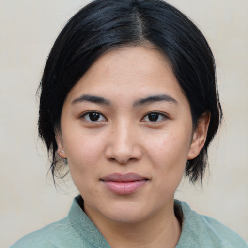Joyful asian young-adult female with medium  black hair and brown eyes