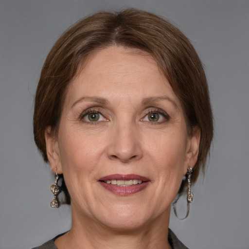 Joyful white adult female with medium  brown hair and grey eyes